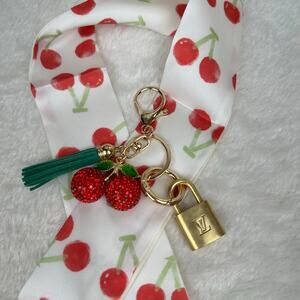 Louis Vuitton Vintage Key on charm w/
scarf looks similar to collab Murakami